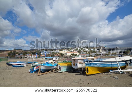 CANARY ISLAND, SPAIN - FEBRUARY 9, 2015: Group of colorful small fishing boats at the beach of San Augustin at the Canary Island in Spain