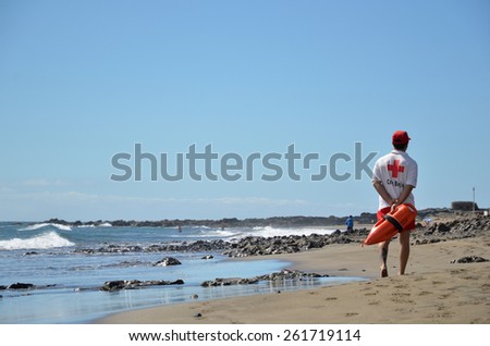 SAN AUGUSTIN, GRAN CANARIA, SPAIN - FEBRUARY 16: A red cross lifeguard is patrolling the beach at the resort San Augustin at the island Gran Canaria in Spain. Photo taken on February 16, 2015 in Spain