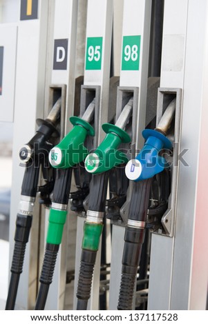 Image of detail of hoses of petrol pump at a gas station, selective focus