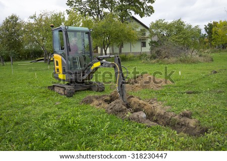 Picture of Excavator at work with man inside