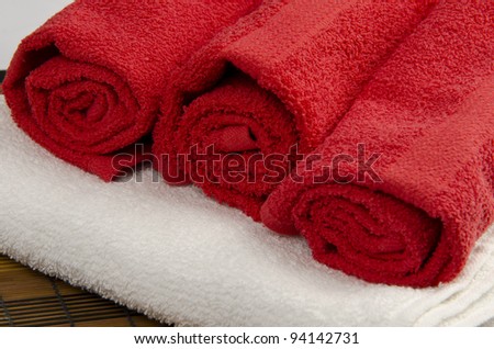 Three red towels on white towel