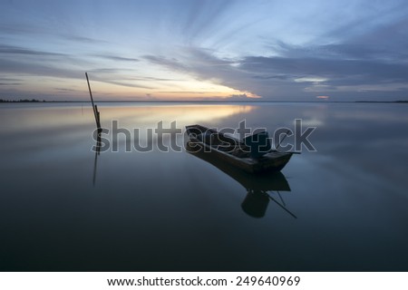 Boat at the beach during dawn times. Slight motion blur on the boat due to long exposure.