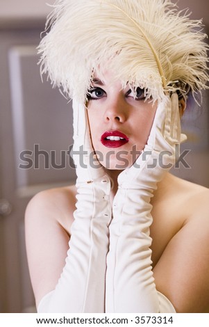 Young woman wearing gloves with a feather hair piece