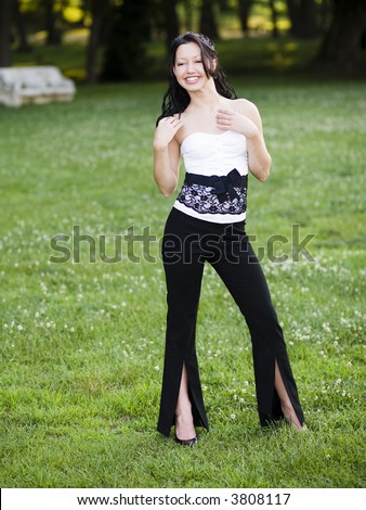 Young woman in black and white sleeveless top and black pants