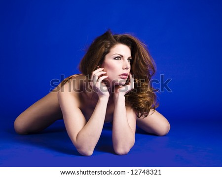 Young woman laying on the floor resting her head in her hands