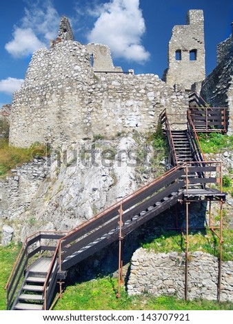 Summer view of preserved interior of ruined Beckov Castle with stairs for visitors. The Castle of Beckov is situated in village Beckov located in western Slovakia, Trencin region.