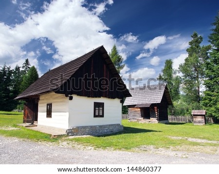 Summer view of rare wooden folk houses located in open-air museum of Liptov Village, Slovakia. This open-air museum shows typical folk architecture of Slovak rural communities in the past.