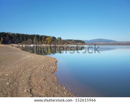 Summer view of shore of Orava reservoir lake. Orava reservoir is one of the largest water reservoirs (area 35.2 km2) in Slovakia. It is favorite summer recreation destination of tourists.