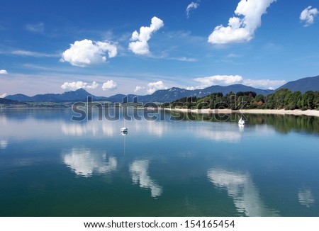 Summer view of Liptovska Mara lake (dam) with yachts and Choc mountain in distance. Location of Liptovska Mara is popular summer holiday recreation destination for travelers.