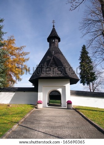 Autumn view of main fortified gate leading to complex of wooden church of All Saints in Tvrdosin town, northern Slovakia. This 15th century church is declared UNESCO heritage since 2008.