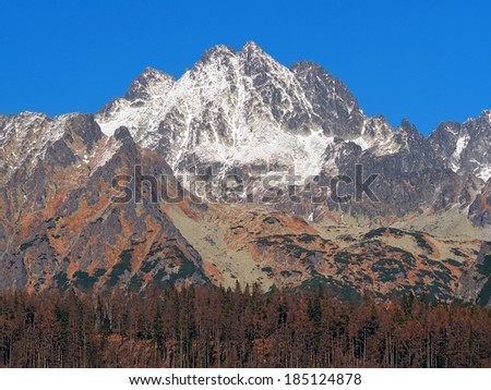 Autumn at High Tatras peaks with first snow on top. Names of these peaks are: Tazky stit (alt. 2520 meters), Vysoka (alt. 2547 meters), Draci stit (alt. 2523 meters) and Osarpance (alt. 2364 meters).