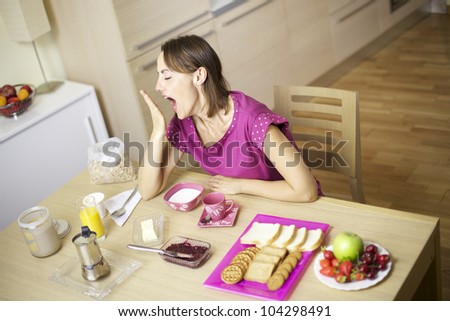 Woman yawning with hand in front of open mouth