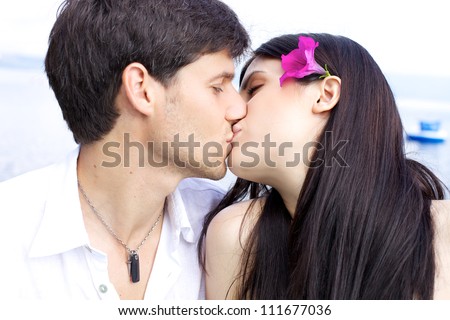 http://image.shutterstock.com/display_pic_with_logo/906433/111677036/stock-photo-beautiful-woman-kissing-her-boyfriend-with-flower-in-her-hair-111677036.jpg