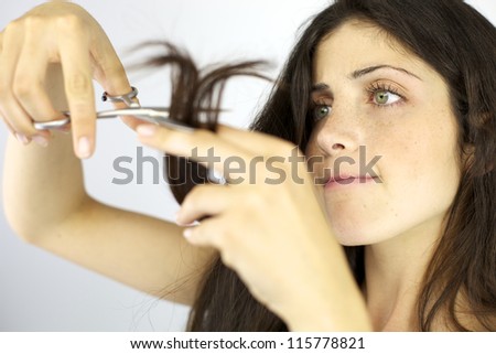 Serious female model ready to cut her long hair