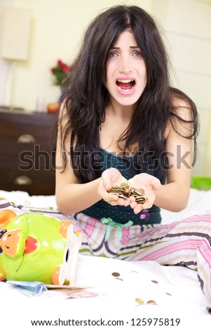 Beautiful woman with no job counting the money she has left in piggy bank shouting