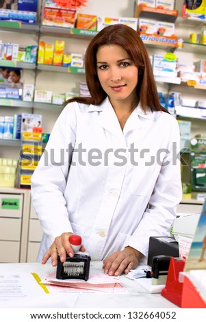 Woman pharmacist happy working in pharmacy smiling/Beautiful doctor working in pharmacy at desk