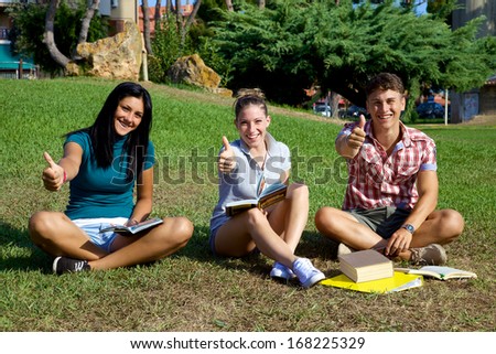 Good looking teenager smiling and having fun studying in park