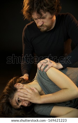 Strong bad violent man looking his abused wife