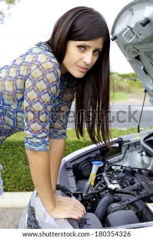 Beautiful woman stressed out for broken engine