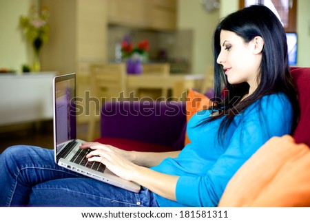 Woman writing with computer smiling happy