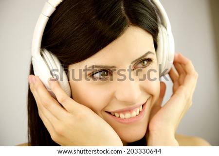 Gorgeous female model happy listening music closeup