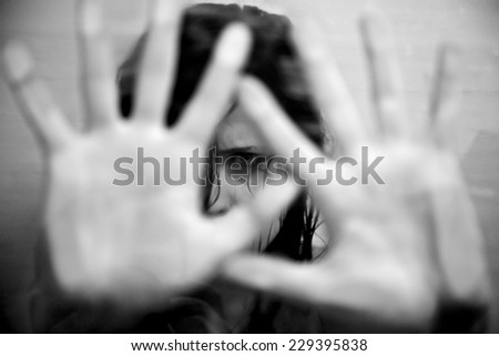 Sad woman scared putting hands in front of face