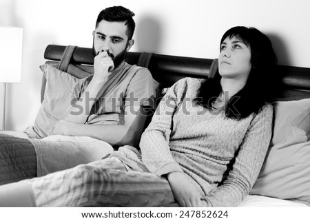 Man and woman thinking in bed after bad fight