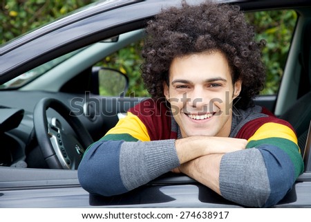 Cool smiling man happy sitting in car