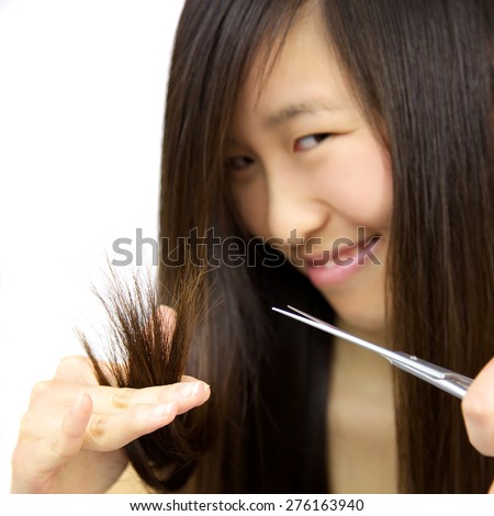 Cute Chinese lady cutting dead ends hair