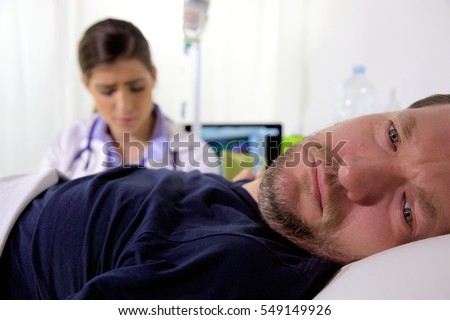 Sad man in bed in hospital feeling ill