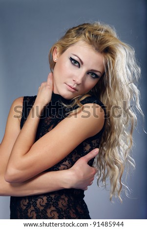 portrait of beautiful sexual woman with blond curly hair dressed in black lacy shirt