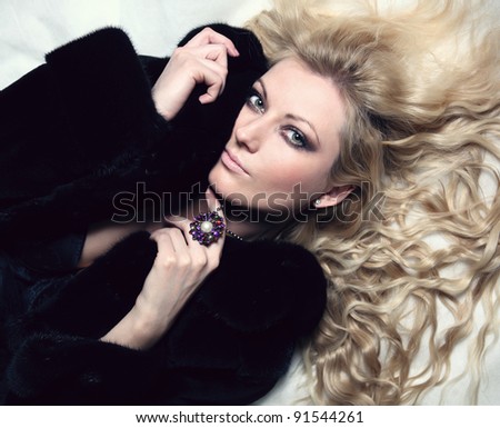 portrait of sexual blond woman dressed in fur and lingerie
