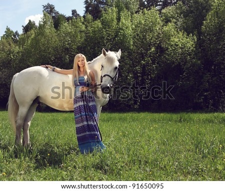 beautiful woman with a horse in the forest