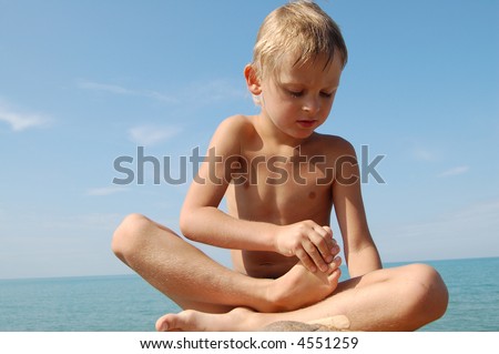 stock photo small naked boy on the stone