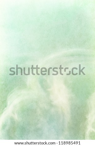 Ethereal and wispy clouds on a textured vintage paper background.  Image has a pleasing paper grain and texture visible at 100%.