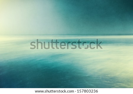 An abstract ocean seascape with blurred panning motion.  Image displays a retro, vintage look with cross-processed colors and a pleasing paper grain and texture.
