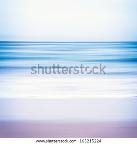 An abstract ocean seascape with blurred panning motion.  Image displays a blue and purple split-toned color scheme.