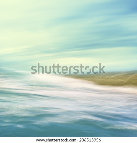 A seascape abstract with panning motion combined with a long exposure.  Image displays soft, pastel colors in a retro style.
