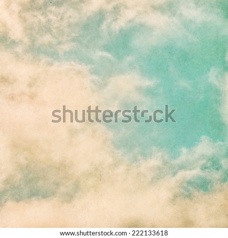 Fog and clouds on a grunge paper background.  Image displays significant grain and texture at 100 percent.