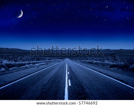 A desert road at night leading off into infinity.