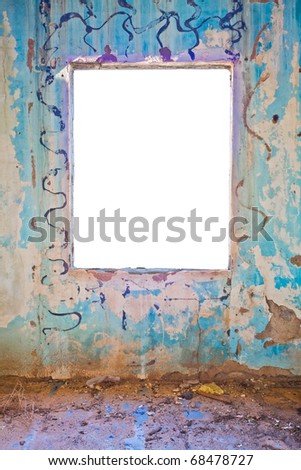 A damaged and abandoned building interior featuring a colorful grunge wall with a window cut-out in pure white.  File includes a clipping path.