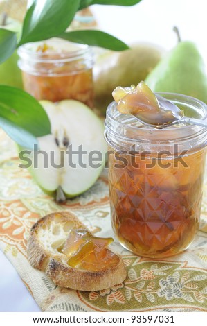 Pear homemade marmalade in a jar with toasted bread