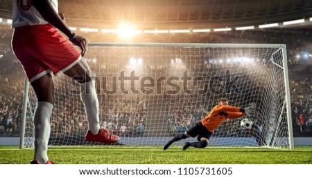 Soccer player is trying to score a goal while goalkeeper defends on a professional soccer stadium. Stadium and crowd are made in 3D.