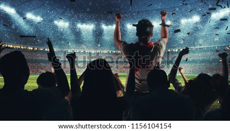 Fans celebrating the success of their favorite sports team on the stands of the professional stadium while it\'s snowing. Stadium is made in 3D.