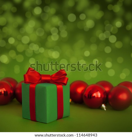 Cute Green Gift With Red Christmas Balls On Green Abstract Light Background Stock Photo