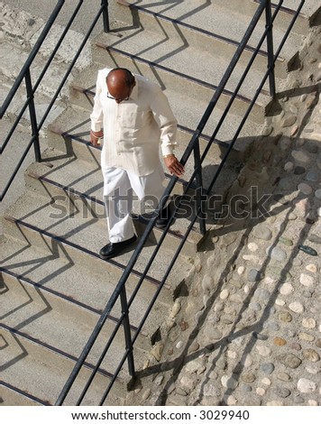 Indian man walking down some stairs
