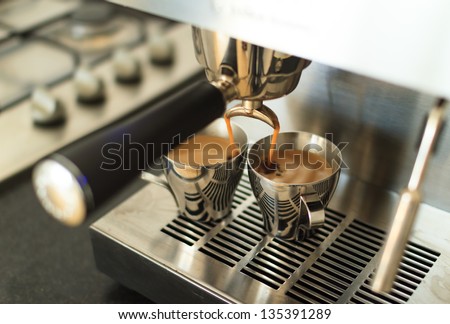 Brewing two espresso\'s on a modern home espresso machine.