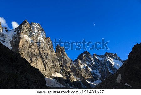 Moon above the mountains and big walls in the French Alps. (National Park Ecrin)