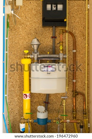 Gas, water and electrical meter on a meter cupboard in a modern home.