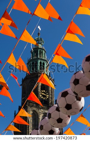 Orange flags and footballs in front of the Martinitoren, Groningen, at the world soccer cup of 2014.